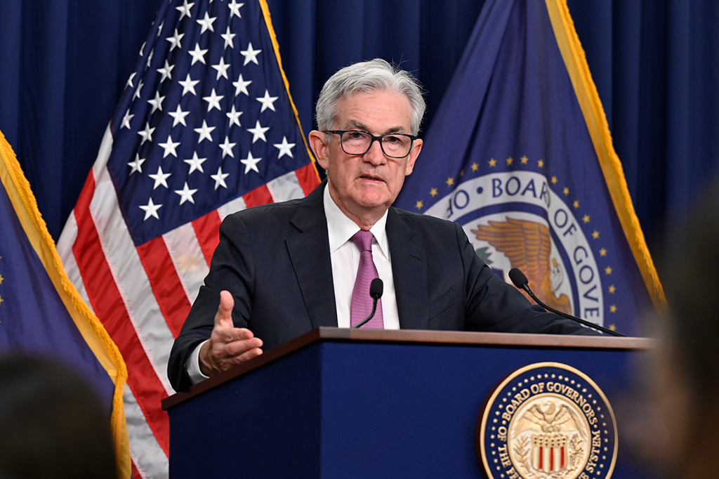 Jerome Powell at the podium, hands out